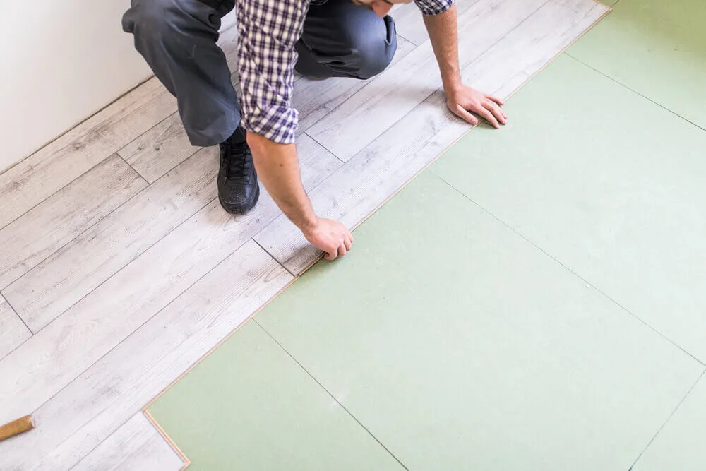 worker processing flooring board