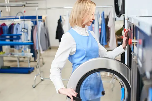 woman loading laundry into washing machine